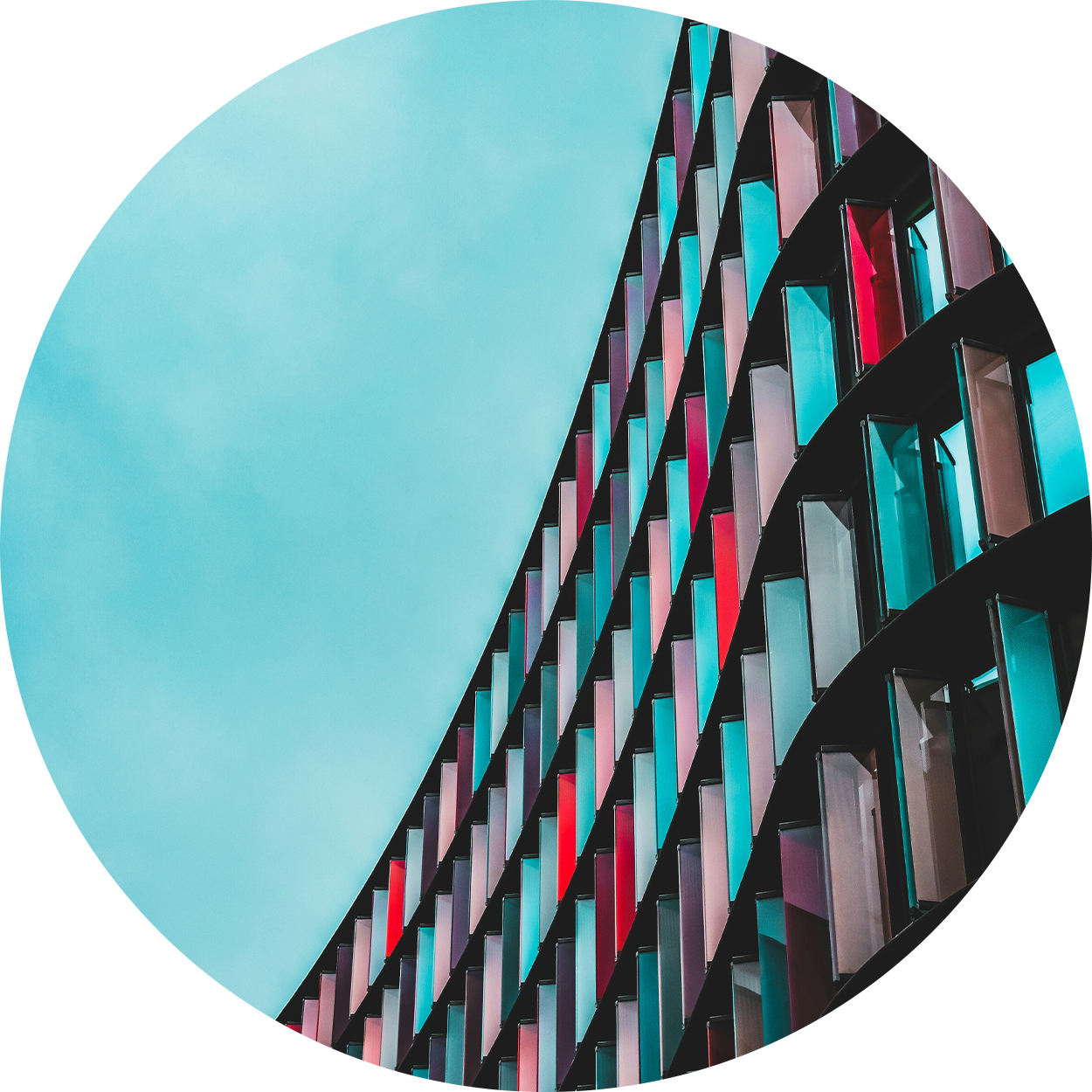 Red and blue geometric windows against a blue sky
